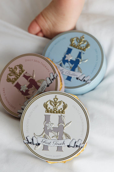 Royal Heir Botanicals tins of organic, plant-based butters with different aromatherapy support . EWG verified First Touch butter safe for babies from day 1, the next best thing to Vernix. Royal Heir Butter on Pink for the most delicate areas for baby and grown girls to help control growth of yeast on the skin, soothing and cooling for vulvoaginitis and dry vaginal burning. Royal Heir formula in Blue perfect for eczema sufferers of any age, supports the skin with Cocoa, Shea butters and Oat kernel oil