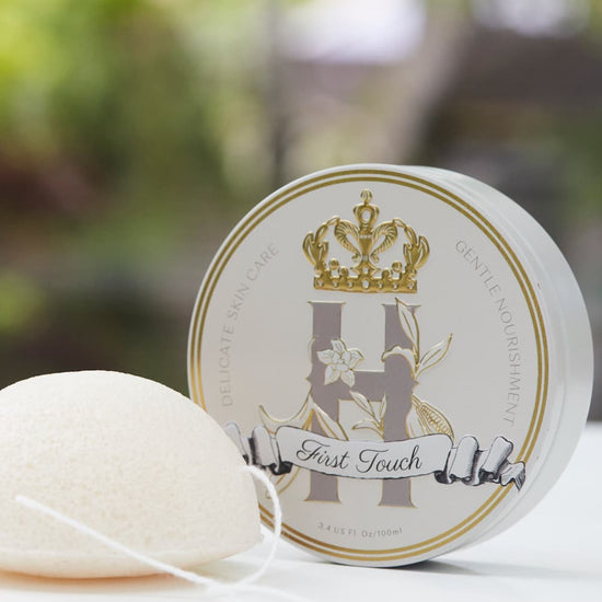 Royal Heir Botanicals First Touch Butter and a gentle Konjac sponge making up a First Touch ritual for a newborn baby. 