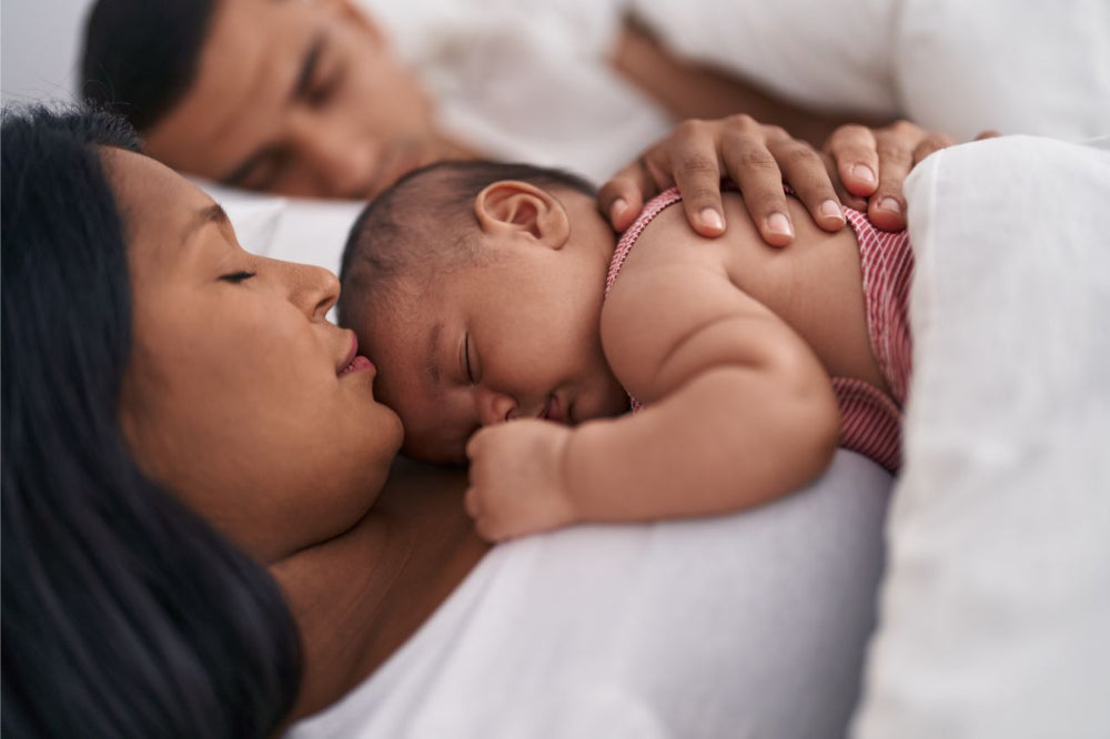 Royal Heir Botanicals_Tired mom with baby sleeping on her chest